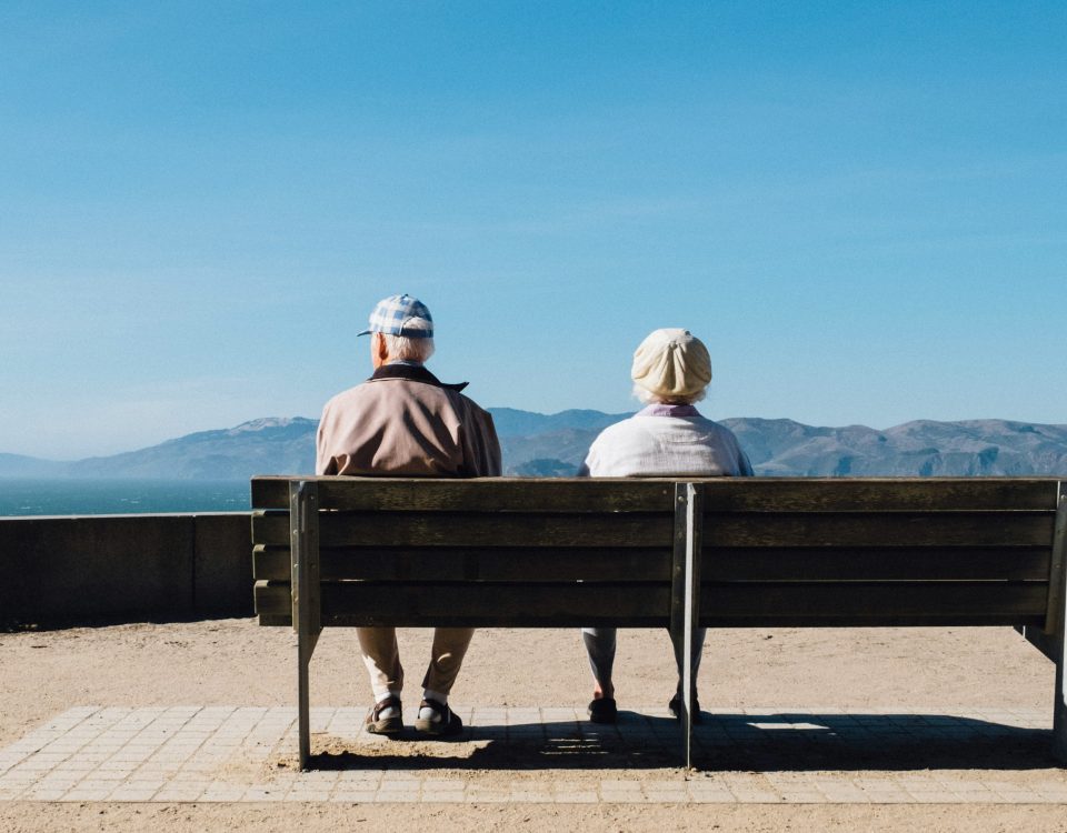Two people sit on a bench.