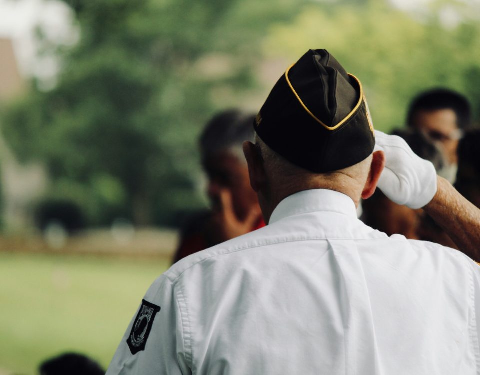An older veteran salutes.