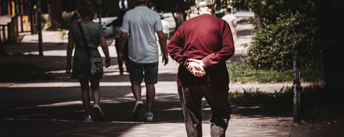 An old man walks down the street.