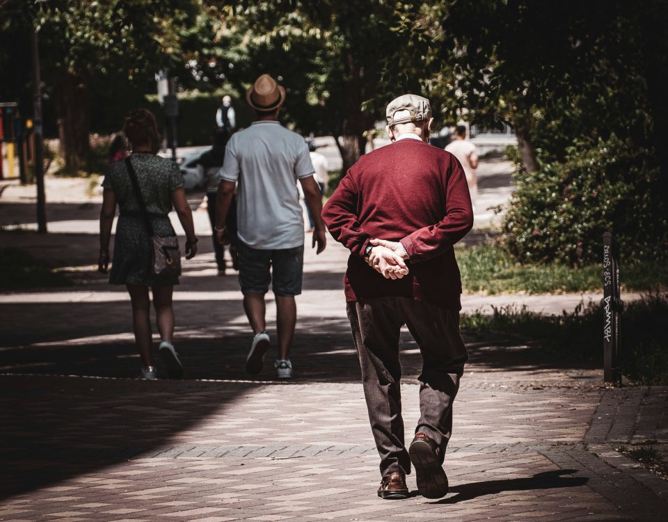 An old man walks down the street.