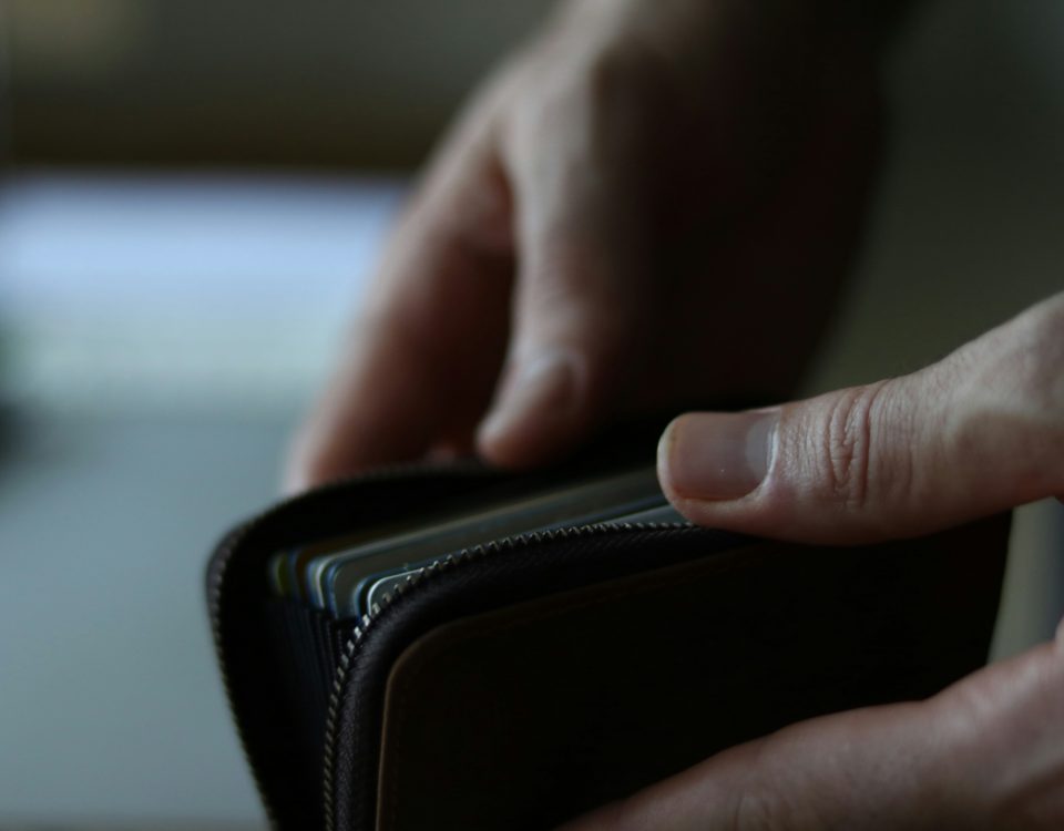 Hands opening a wallet.
