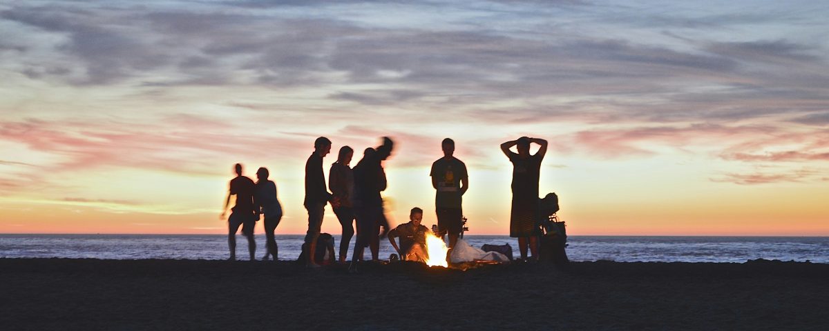 A group of friends outside at dusk.