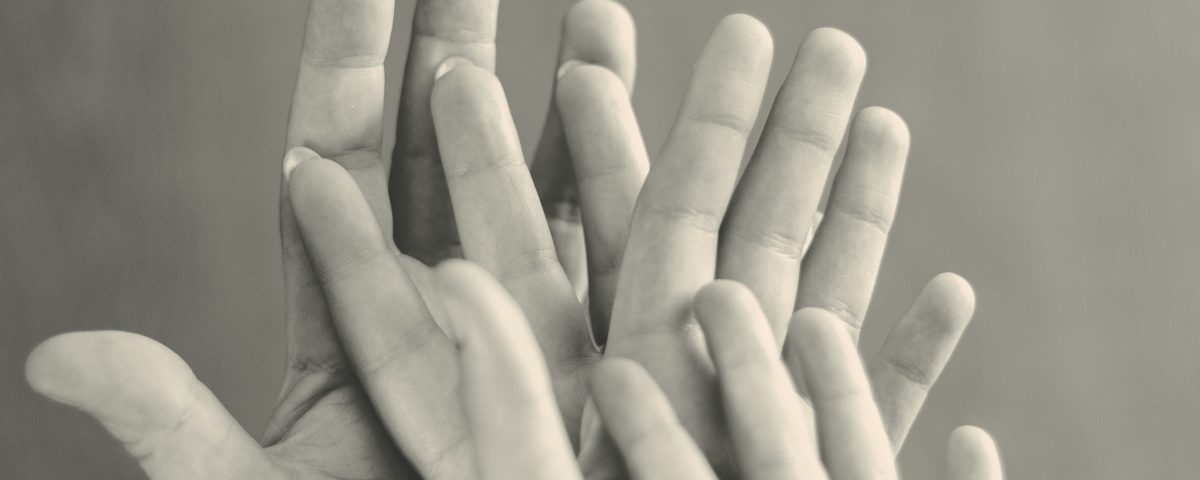Hands on top of each other.