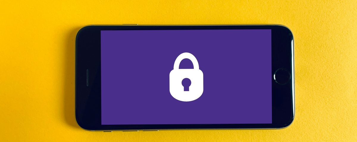 A phone with a lock screen on a yellow background.
