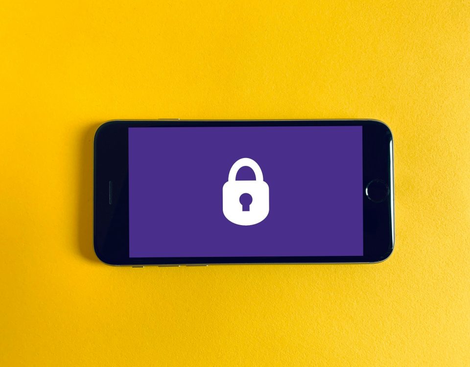A phone with a lock screen on a yellow background.