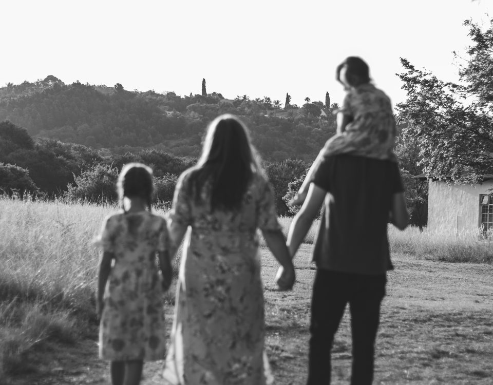 A black and white image of a family walking away.